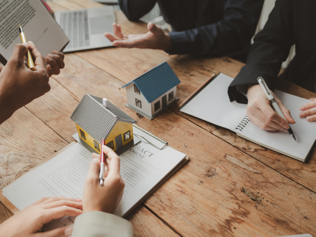 Real Estate Professionals Reviewing Documents at Workplace